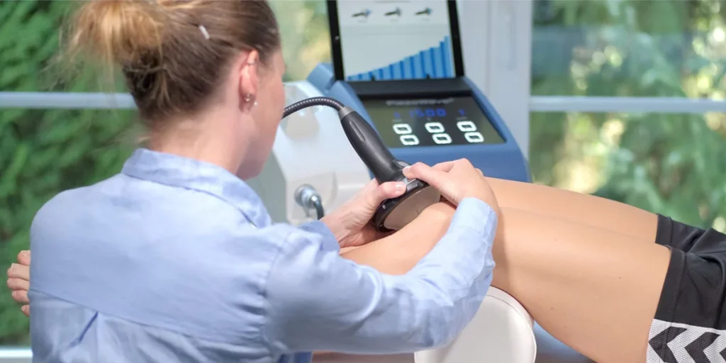 Chiropractor performing Piezowave focused shockwave therapy on a patient